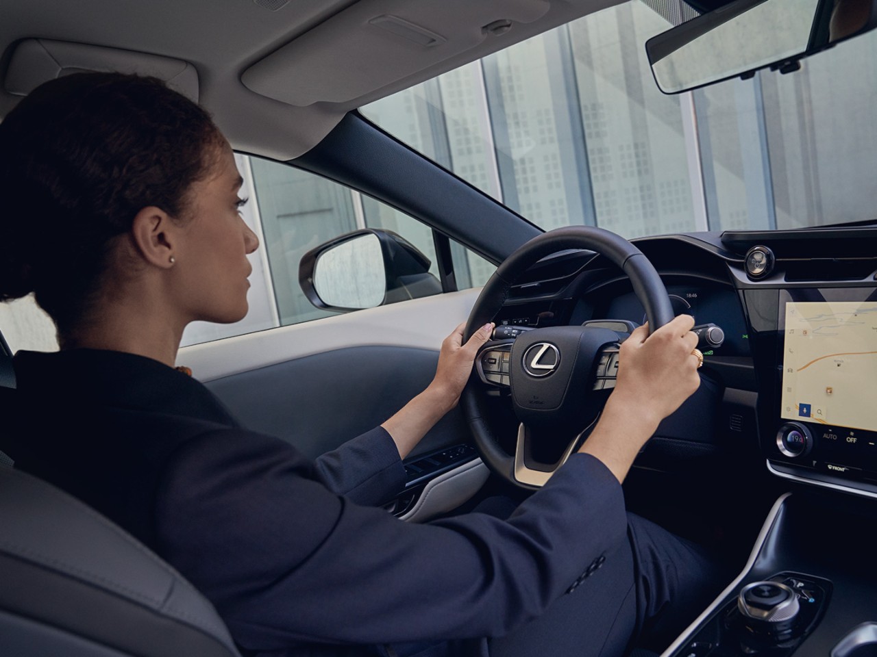 A Lexus UX 300e driving round a corner