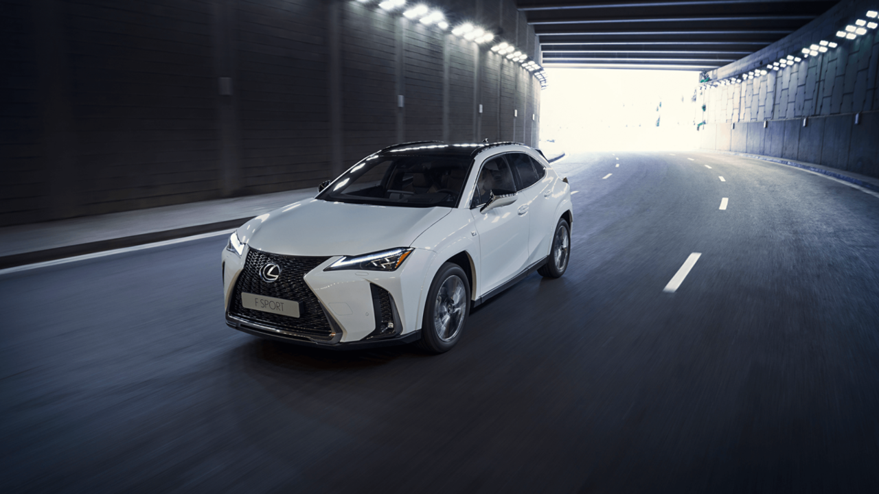  Lexus UX driving down a road