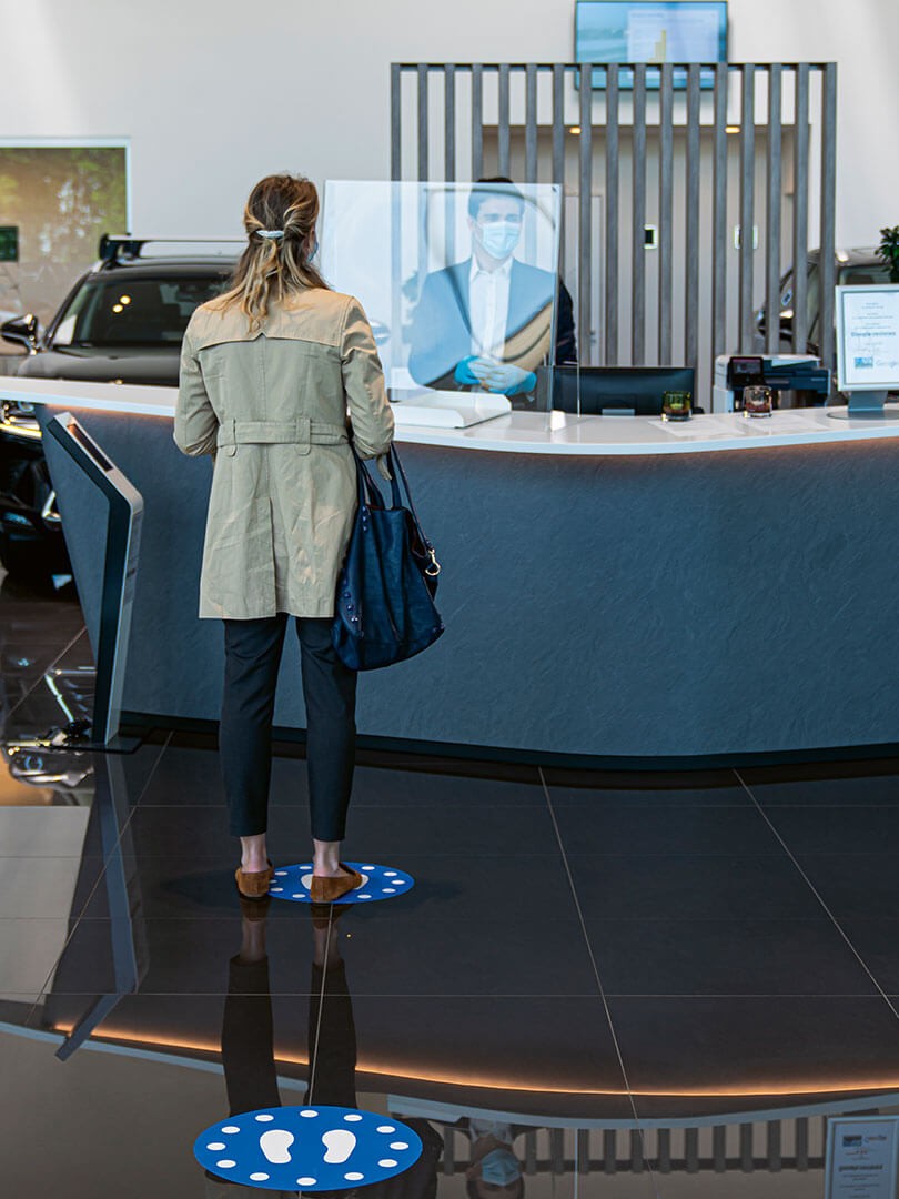 A woman being served in a Lexus dealership 